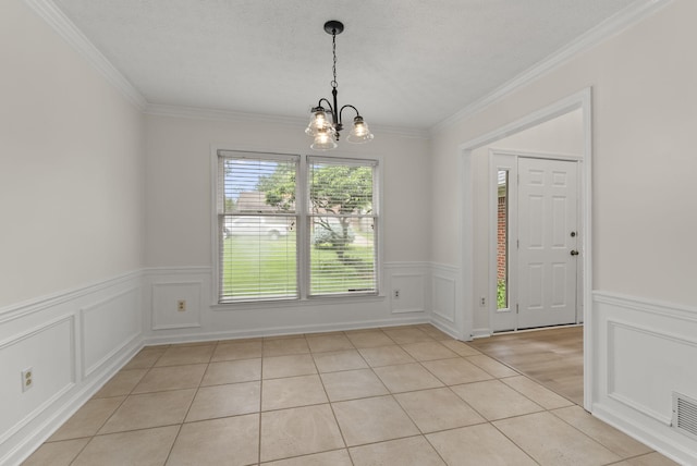 1048 Vero Ct, Lexington, KY 40509 - unfurnished dining area with a chandelier, a wainscoted wall, ornamental molding, a decorative wall, and light tile patterned floors