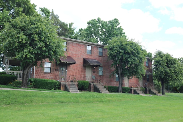 382 W Main St, Carlisle, KY 40311 - view of front of home featuring brick siding and a front yard