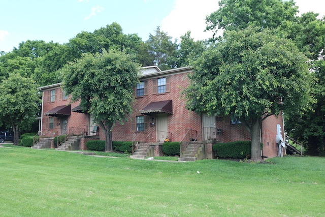 382 W Main St, Carlisle, KY 40311 - view of front facade featuring brick siding and a front lawn