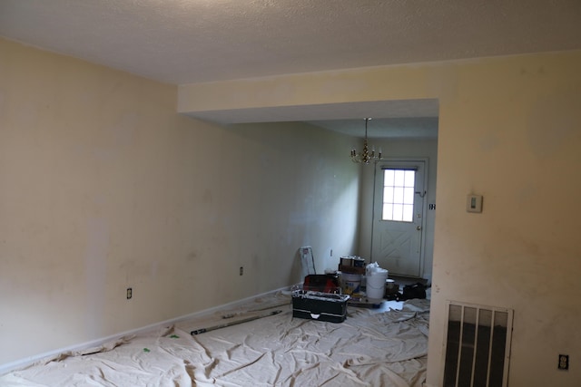 382 W Main St, Carlisle, KY 40311 - unfurnished living room featuring carpet floors and a chandelier