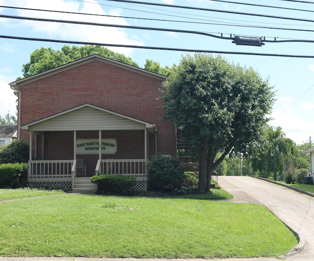 382 W Main St, Carlisle, KY 40311 - view of front of property with brick siding, covered porch, and a front yard