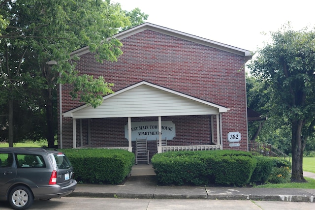 382 W Main St, Carlisle, KY 40311 - view of front of property featuring brick siding and a porch