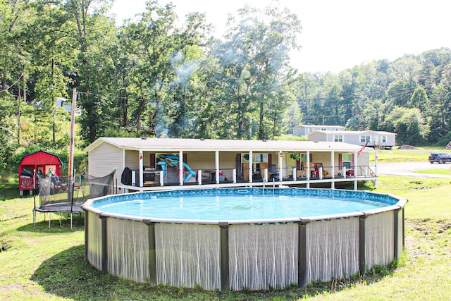 610 Freeman Branch Rd, East Bernstadt, KY 40729 - swimming pool featuring a lawn and a trampoline