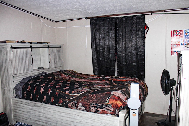 610 Freeman Branch Rd, East Bernstadt, KY 40729 - bedroom with a textured ceiling and wood finished floors