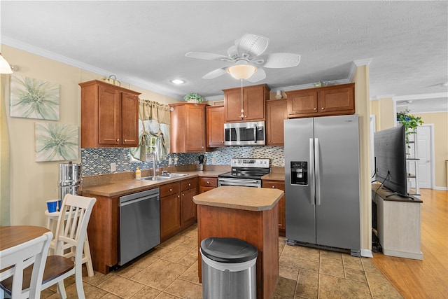 1809 Pine Top Rd, London, KY 40741 - kitchen with appliances with stainless steel finishes, crown molding, tasteful backsplash, a ceiling fan, and a kitchen island