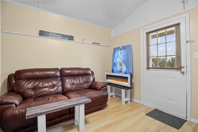 1809 Pine Top Rd, London, KY 40741 - living room featuring lofted ceiling, wood finished floors, a glass covered fireplace, and crown molding