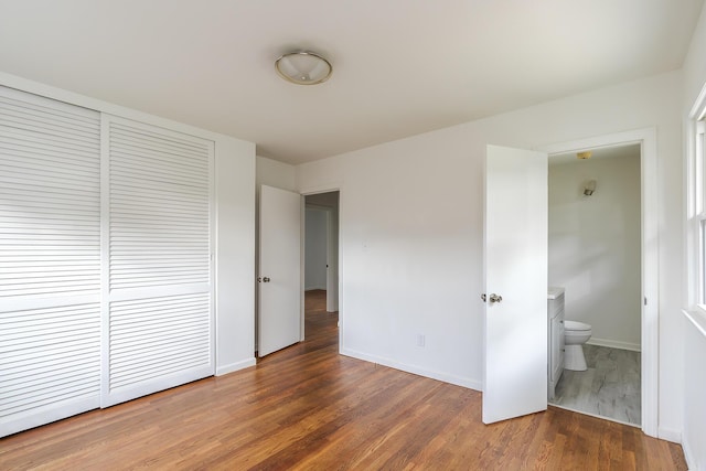 139 Tartan Dr, Lexington, KY 40517 - unfurnished bedroom with wood finished floors, a closet, and connected bathroom