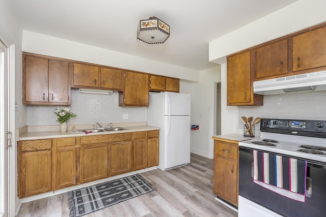 139 Tartan Dr, Lexington, KY 40517 - kitchen featuring electric range oven, freestanding refrigerator, under cabinet range hood, brown cabinetry, and light countertops