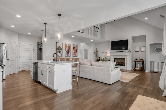1912 Tidewater Flt, Lexington, KY 40509 - kitchen with stainless steel dishwasher, a towering ceiling, a kitchen breakfast bar, light countertops, and dark wood-style floors