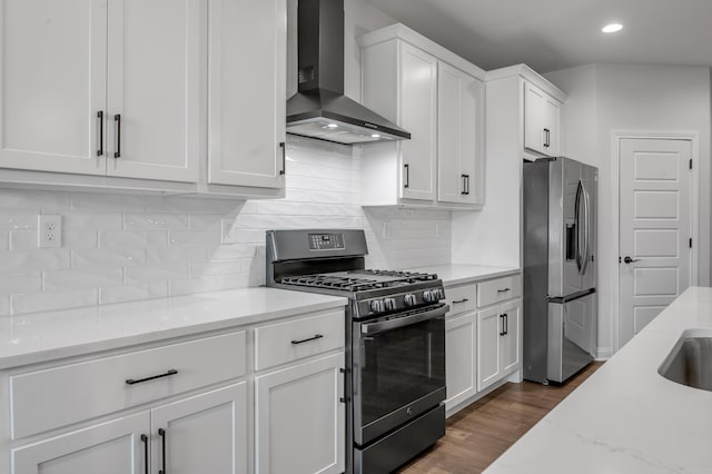 1912 Tidewater Flt, Lexington, KY 40509 - kitchen with appliances with stainless steel finishes, wall chimney exhaust hood, white cabinets, decorative backsplash, and dark wood finished floors
