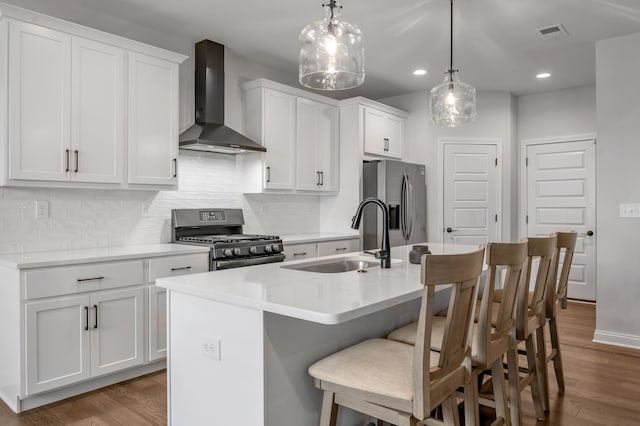 1912 Tidewater Flt, Lexington, KY 40509 - kitchen featuring wall chimney exhaust hood, stainless steel appliances, wood finished floors, recessed lighting, and a center island with sink