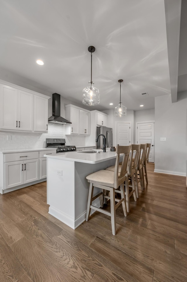 1912 Tidewater Flt, Lexington, KY 40509 - kitchen featuring wall chimney exhaust hood, appliances with stainless steel finishes, recessed lighting, a large island with sink, and dark wood finished floors