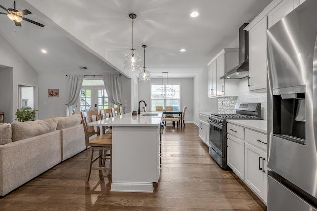 1912 Tidewater Flt, Lexington, KY 40509 - kitchen featuring appliances with stainless steel finishes, wall chimney exhaust hood, open floor plan, a kitchen breakfast bar, and recessed lighting