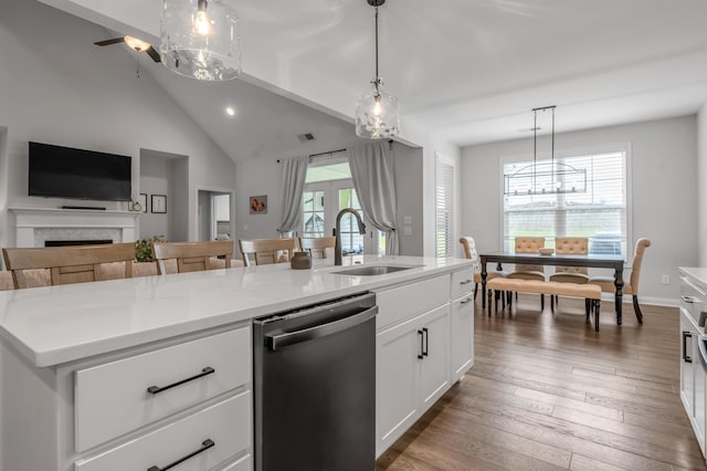 1912 Tidewater Flt, Lexington, KY 40509 - kitchen featuring dishwasher, a chandelier, open floor plan, a fireplace, and light countertops