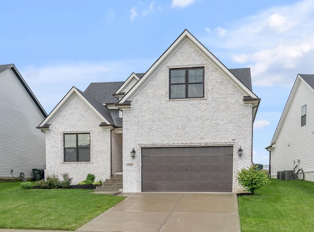 1912 Tidewater Flt, Lexington, KY 40509 - view of front of house featuring an attached garage, brick siding, and a front lawn