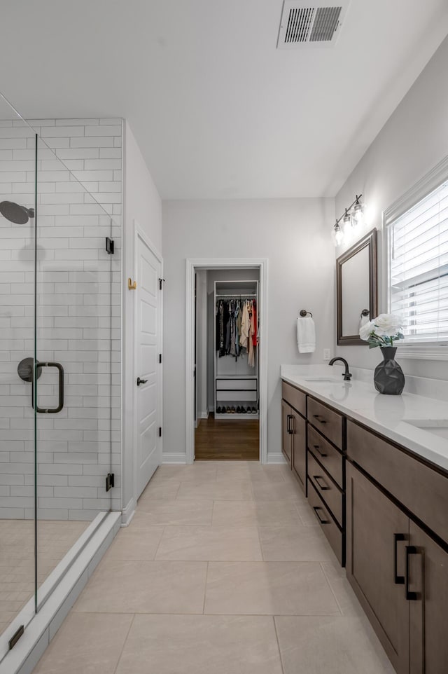 1912 Tidewater Flt, Lexington, KY 40509 - full bath featuring double vanity, a stall shower, a spacious closet, and tile patterned flooring