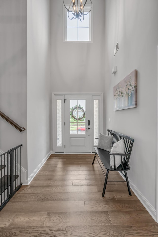 1912 Tidewater Flt, Lexington, KY 40509 - foyer featuring a high ceiling, a chandelier, plenty of natural light, and wood finished floors