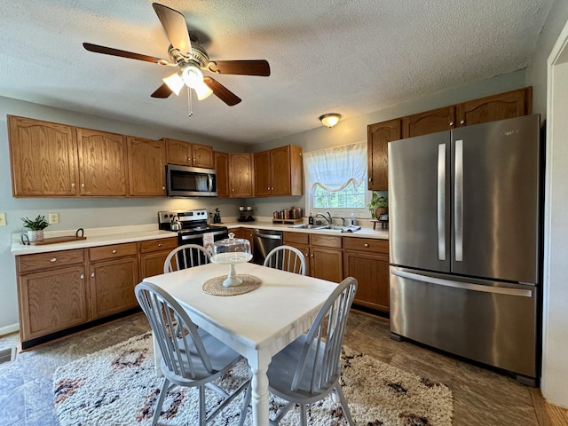 120 Lanetown Rd, Nancy, KY 42544 - kitchen with appliances with stainless steel finishes, light countertops, ceiling fan, brown cabinets, and a textured ceiling