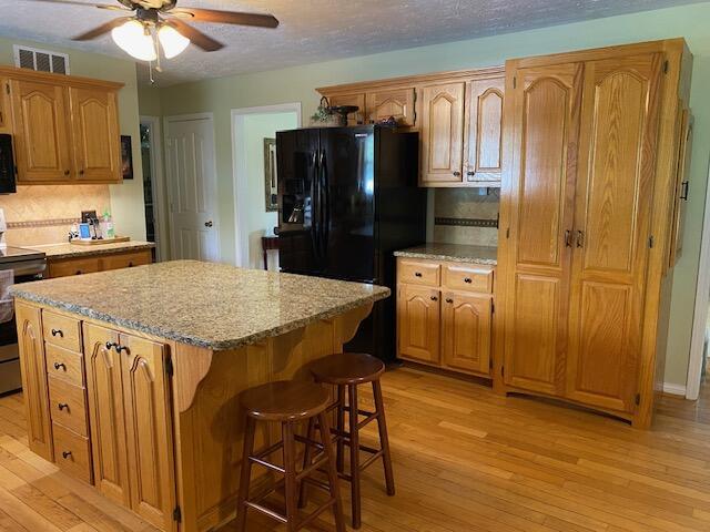 407 Autumn Dr, Lancaster, KY 40444 - kitchen featuring black appliances, ceiling fan, and light wood finished floors