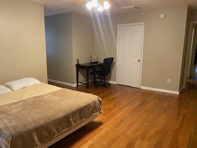 407 Autumn Dr, Lancaster, KY 40444 - bedroom with a textured ceiling, wood finished floors, and ceiling fan