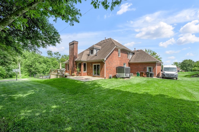 315 The Woods Ln, Winchester, KY 40391 - back of house featuring brick siding, a chimney, a yard, and a patio area