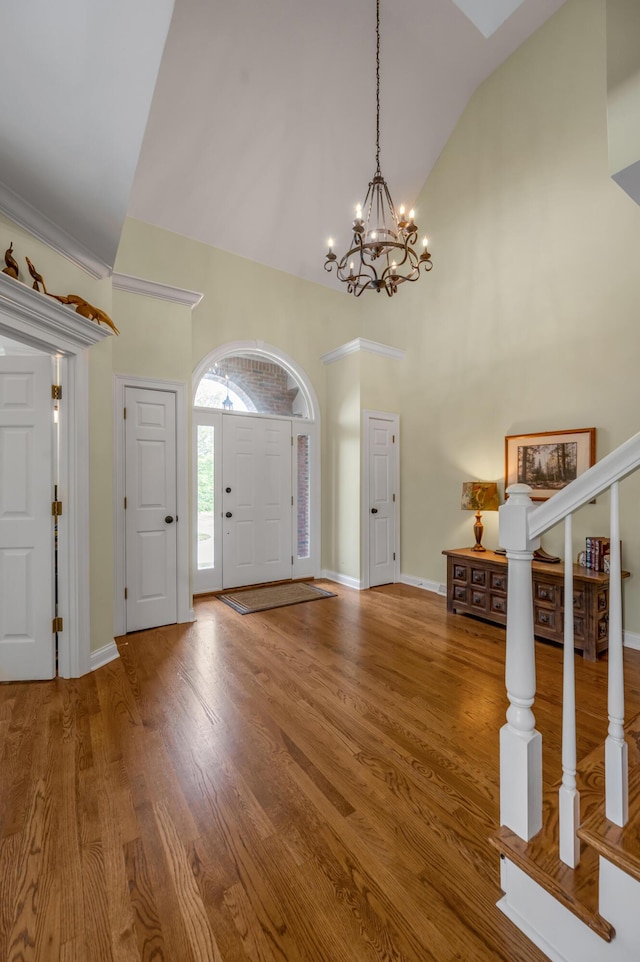 315 The Woods Ln, Winchester, KY 40391 - entryway with a chandelier, wood finished floors, high vaulted ceiling, and stairs