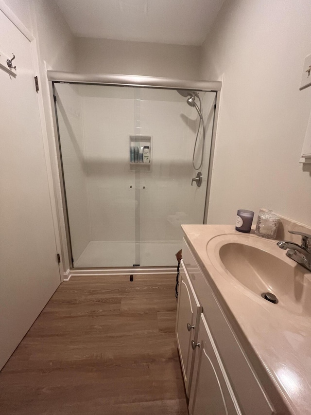 1185 Oak Ridge Rd, Corbin, KY 40701 - full bathroom with a stall shower, wood finished floors, and vanity