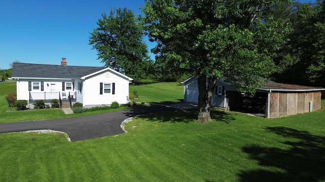 1185 Oak Ridge Rd, Corbin, KY 40701 - view of grassy yard with an outbuilding, a garage, and driveway