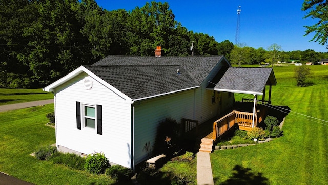 1185 Oak Ridge Rd, Corbin, KY 40701 - view of property exterior with roof with shingles, a lawn, and a chimney