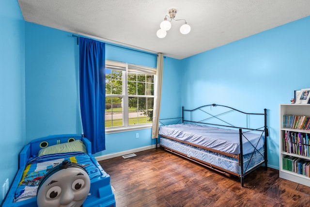 332 Weslyn Way, Nicholasville, KY 40356 - bedroom featuring wood finished floors, a textured ceiling, and a chandelier