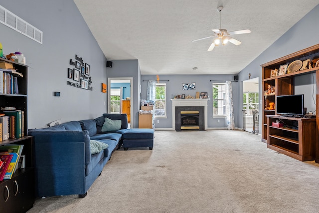 332 Weslyn Way, Nicholasville, KY 40356 - carpeted living area featuring a textured ceiling, ceiling fan, a tile fireplace, and lofted ceiling