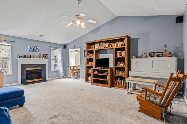 332 Weslyn Way, Nicholasville, KY 40356 - living area with a ceiling fan, lofted ceiling, carpet flooring, a textured ceiling, and a tile fireplace
