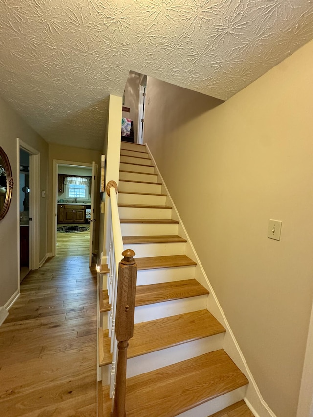 4295 Vince Rd, Nicholasville, KY 40356 - staircase featuring wood finished floors and a textured ceiling