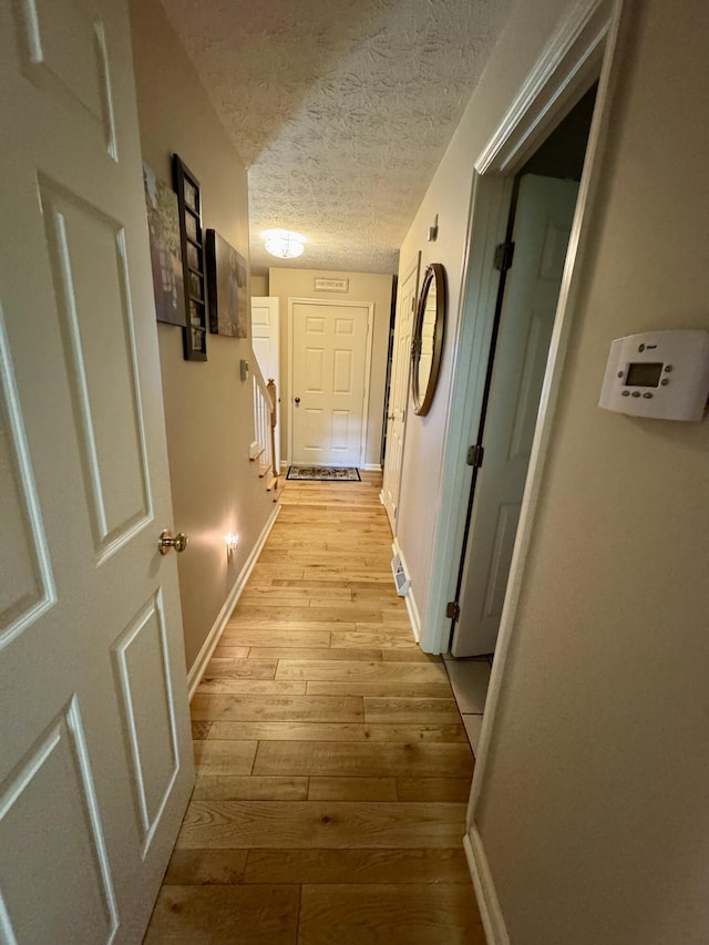 4295 Vince Rd, Nicholasville, KY 40356 - corridor with light wood-style floors, a textured ceiling, and stairway