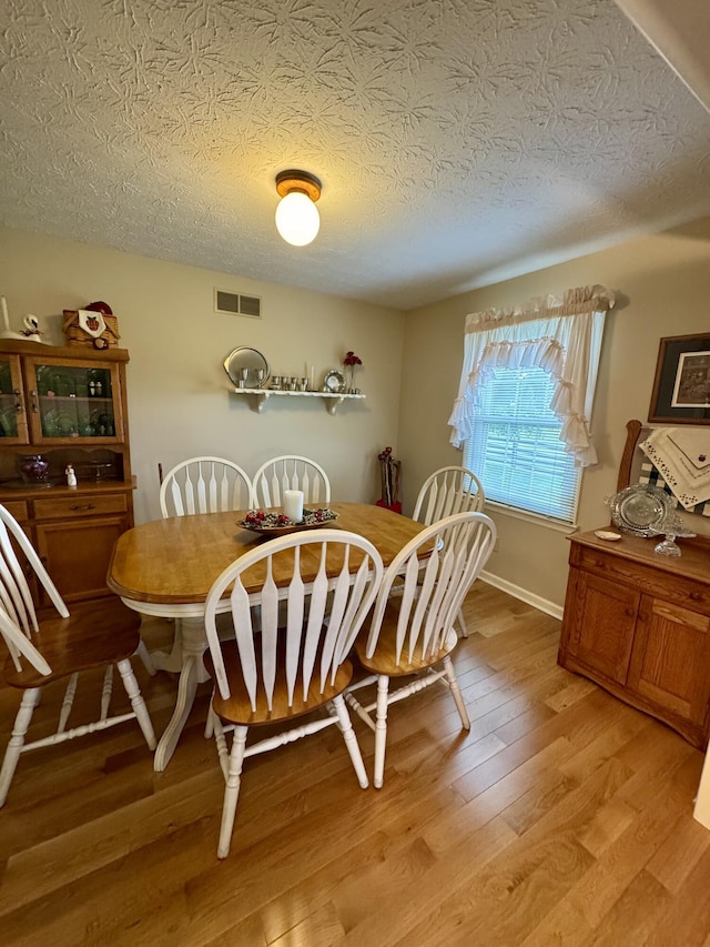 4295 Vince Rd, Nicholasville, KY 40356 - dining room featuring light wood-style floors and a textured ceiling