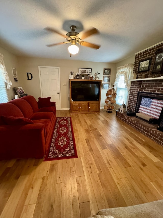 4295 Vince Rd, Nicholasville, KY 40356 - living area featuring wood-type flooring, a fireplace, ceiling fan, and a textured ceiling