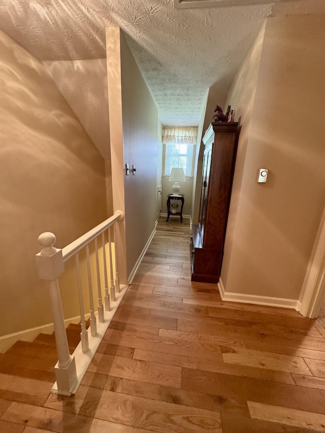 4295 Vince Rd, Nicholasville, KY 40356 - corridor featuring light wood-style floors, a textured ceiling, and an upstairs landing