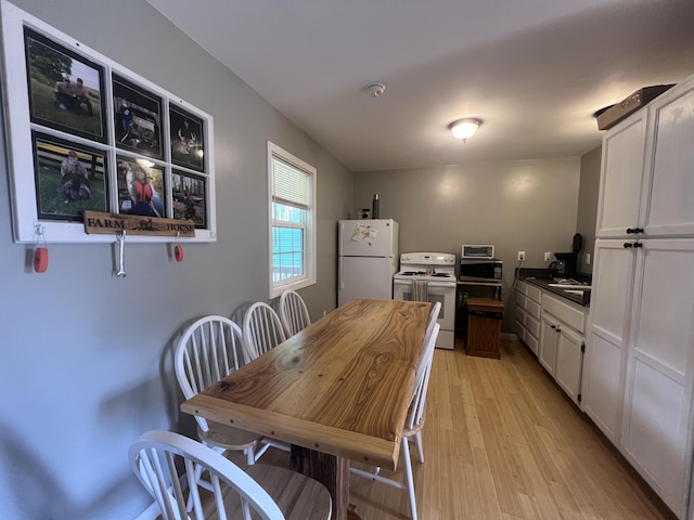 195 Copperhead Rd, Corbin, KY 40701 - kitchen with white appliances, white cabinets, light wood-style flooring, and dark countertops