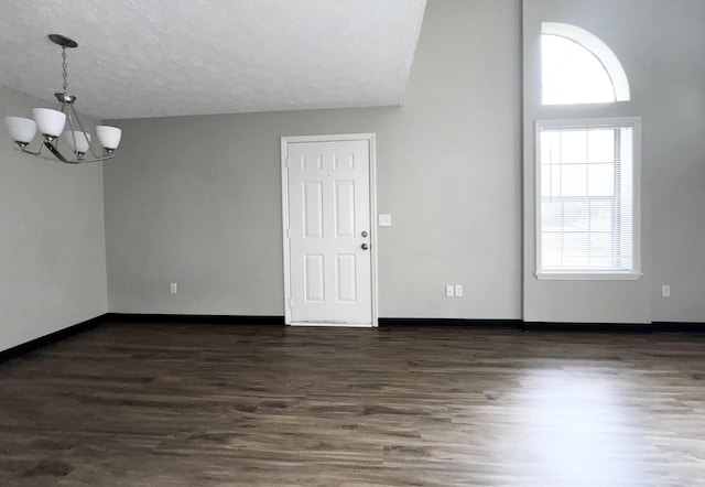 404 Bainbridge Ct Unit E3, Lexington, KY 40509 - unfurnished room featuring a chandelier, plenty of natural light, dark wood finished floors, and a textured ceiling