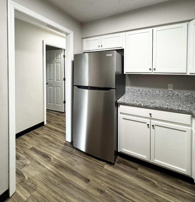 404 Bainbridge Ct Unit E3, Lexington, KY 40509 - kitchen with freestanding refrigerator, white cabinetry, and light stone countertops