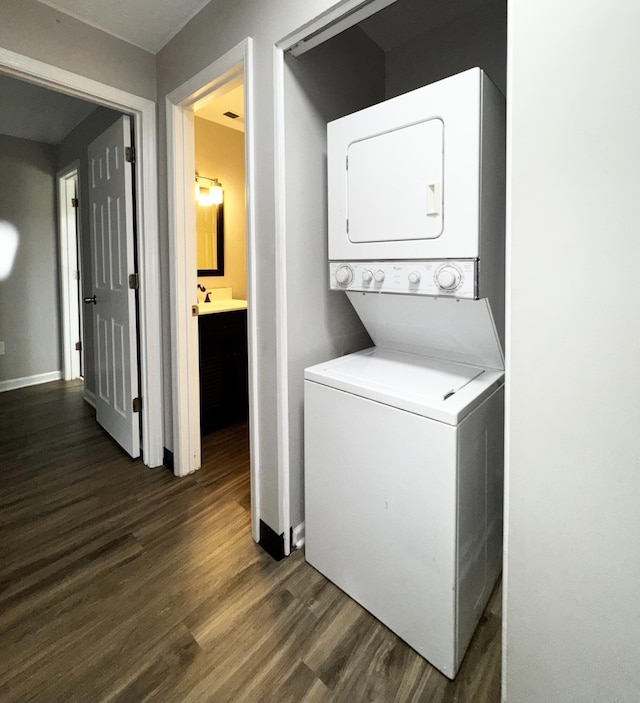 404 Bainbridge Ct Unit E3, Lexington, KY 40509 - washroom with stacked washer and clothes dryer and dark wood-style flooring