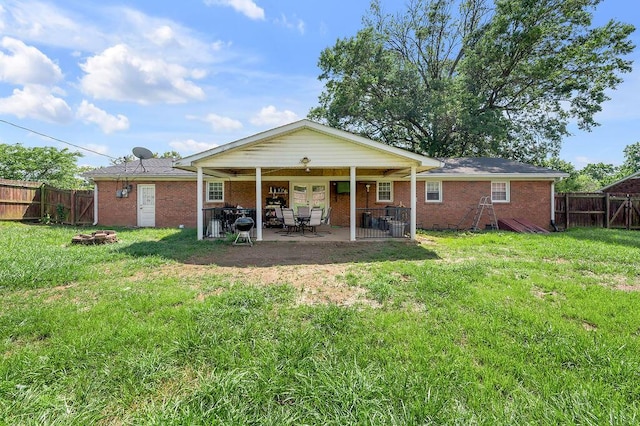 204 Tecumseh Trl, Frankfort, KY 40601 - back of house featuring a fenced backyard, an outdoor fire pit, brick siding, and a patio area