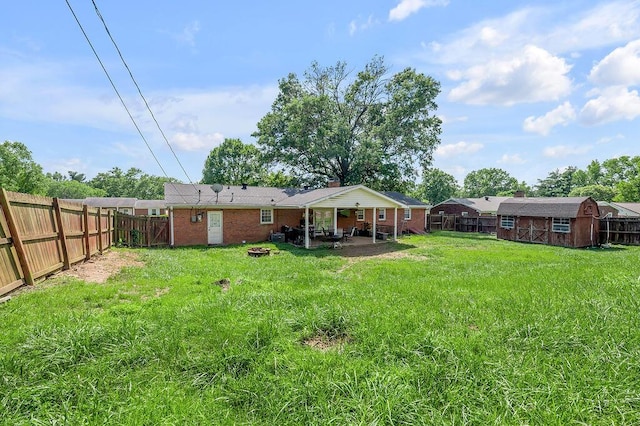 204 Tecumseh Trl, Frankfort, KY 40601 - fenced backyard with an outdoor fire pit, a patio, and a storage shed