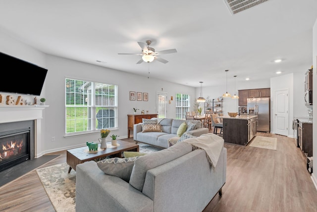 137 Kirkstall Way, Georgetown, KY 40324 - living room with healthy amount of natural light, ceiling fan, a fireplace with flush hearth, light wood finished floors, and recessed lighting
