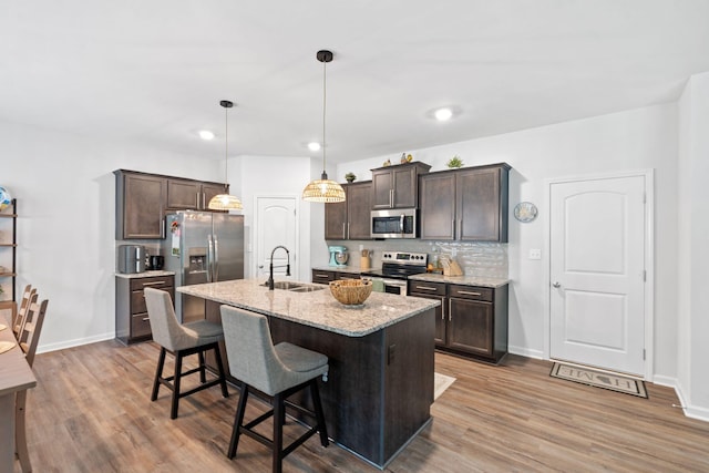 137 Kirkstall Way, Georgetown, KY 40324 - kitchen featuring stainless steel appliances, dark brown cabinetry, backsplash, light wood-style flooring, and recessed lighting