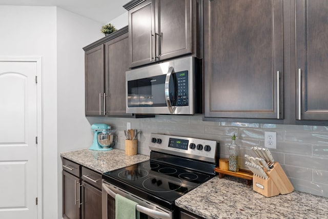137 Kirkstall Way, Georgetown, KY 40324 - kitchen featuring stainless steel appliances, decorative backsplash, dark brown cabinets, and light stone counters