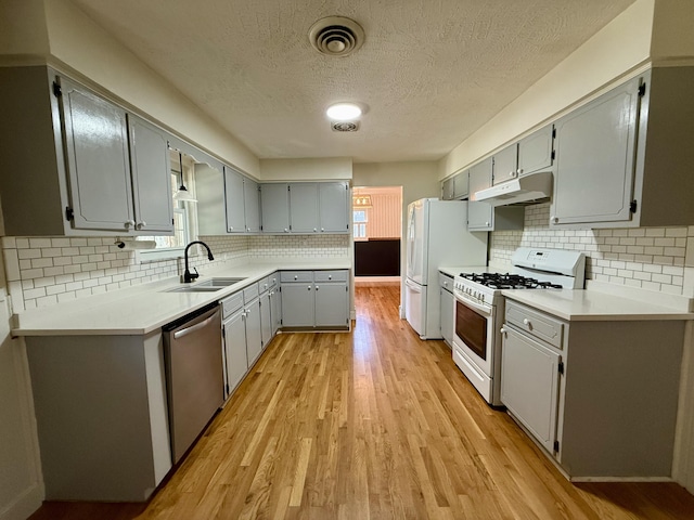 123 Hillandale Dr, Somerset, KY 42501 - kitchen featuring white appliances, under cabinet range hood, a textured ceiling, light wood-type flooring, and tasteful backsplash