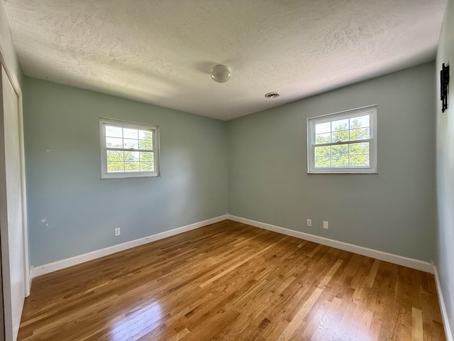 123 Hillandale Dr, Somerset, KY 42501 - spare room with wood finished floors, healthy amount of natural light, and a textured ceiling