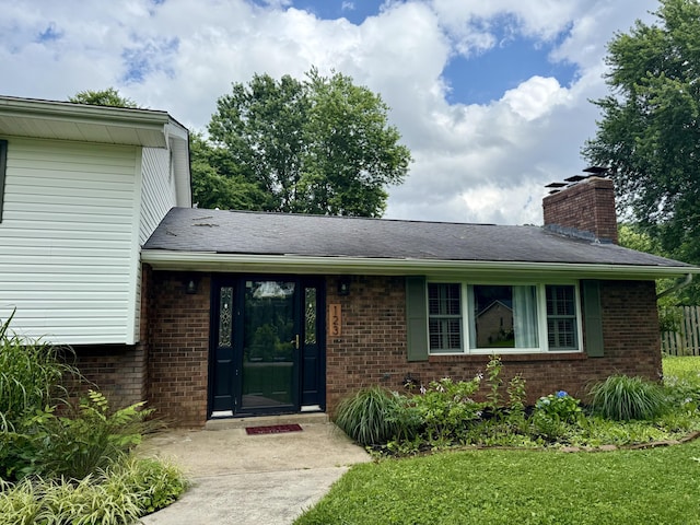 123 Hillandale Dr, Somerset, KY 42501 - doorway to property featuring brick siding, a chimney, and a lawn