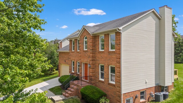 4433 River Ridge Rd, Lexington, KY 40515 - view of property exterior with a chimney, an attached garage, driveway, and brick siding